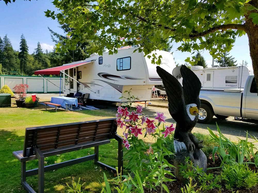 Fifth-wheel parked in a lush campsite with plenty of room.