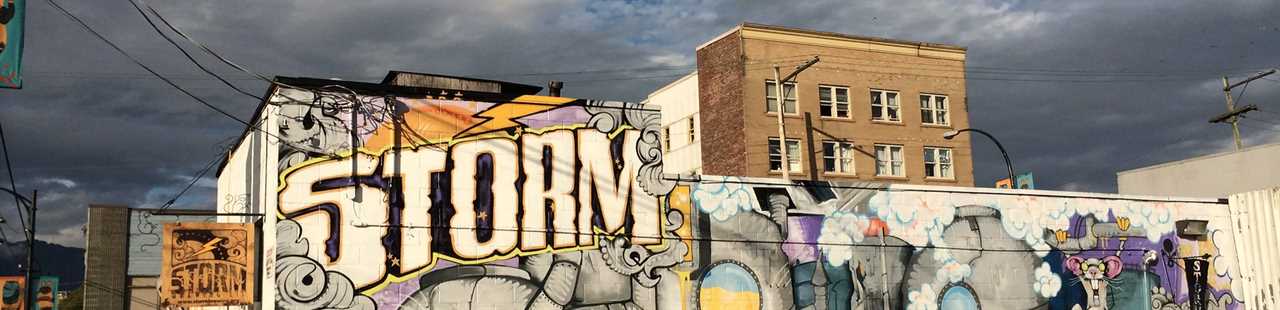 Side of a building with the word, "storm" painted on.