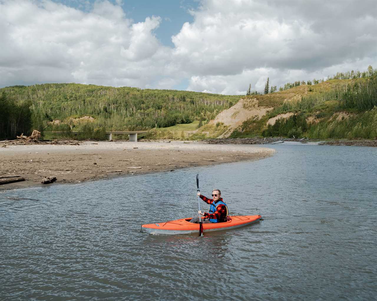 A lone kayaker on a stream.