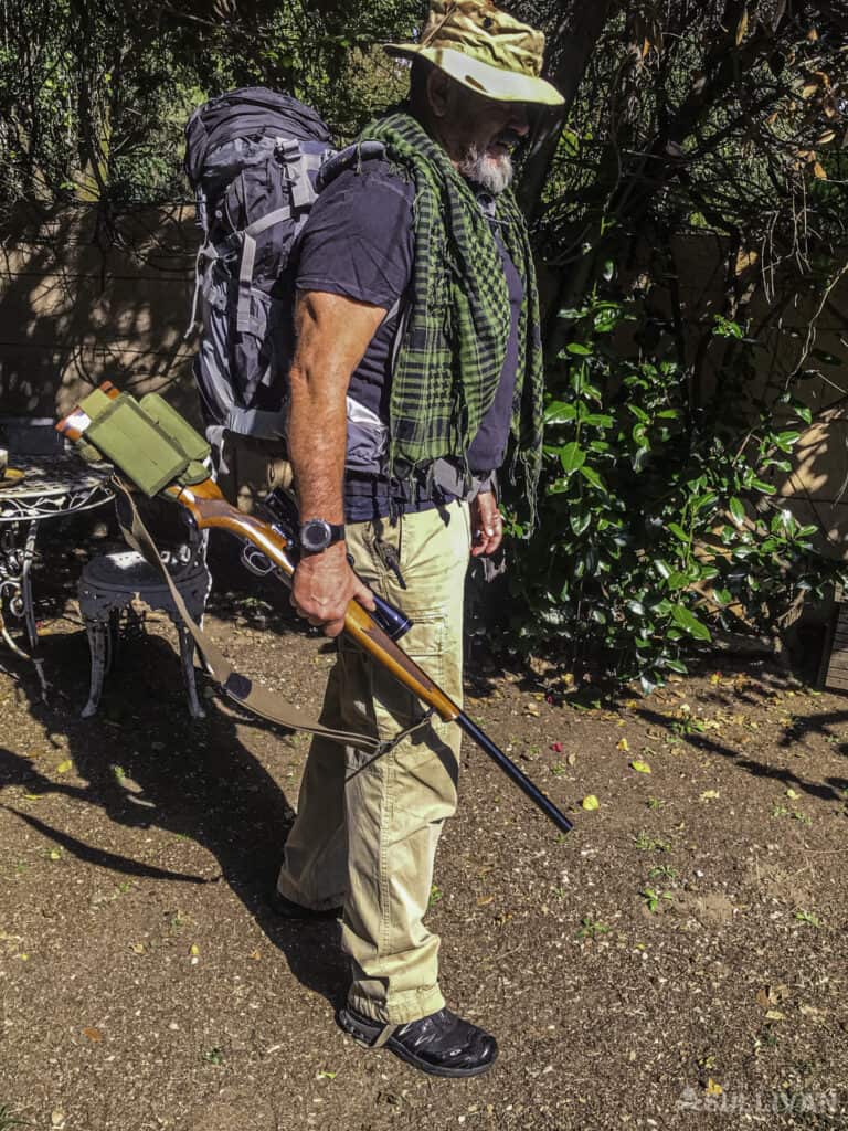 Harrison Caine ready to go hunting, with his backpack, hunting rifle, bandana and hat