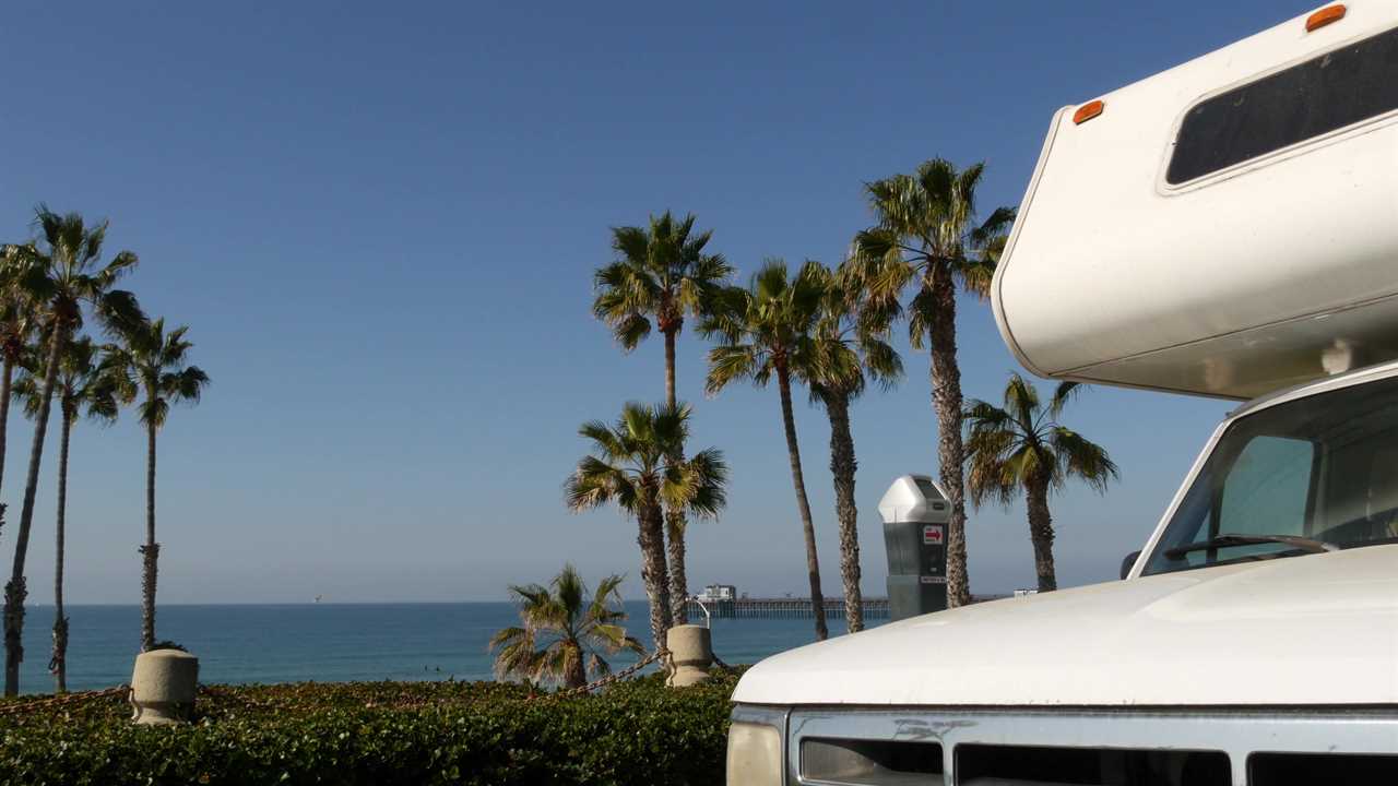 Class C motorhome parked at the beach.