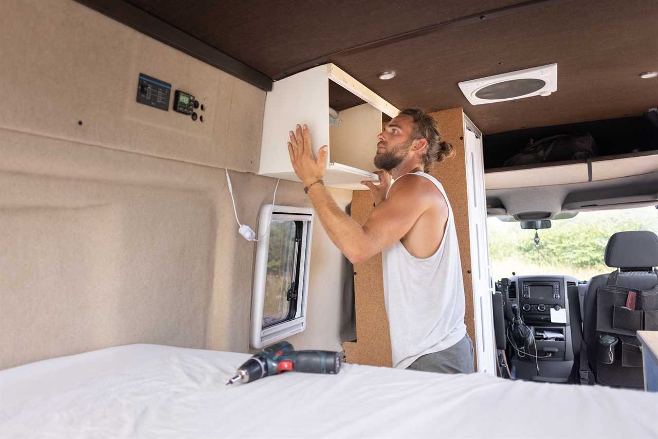 Man performing maintenance tasks on an RV.