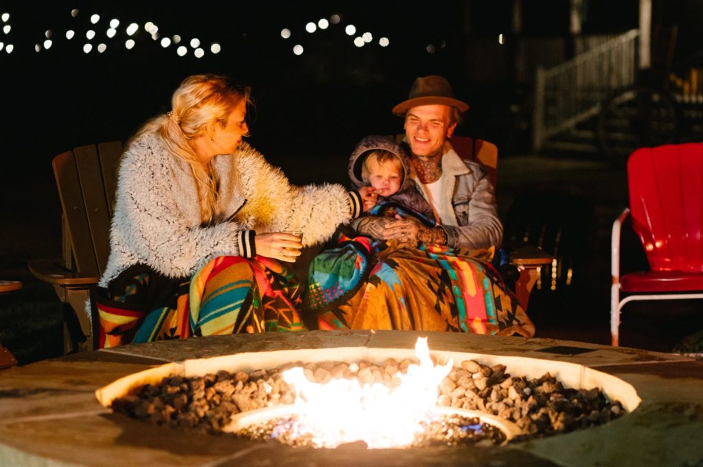 Family Around Fire Pit at Campsite