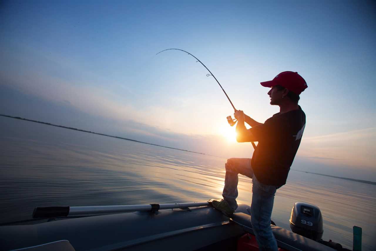 Angler hauling in a catch that significantly bends his pole.