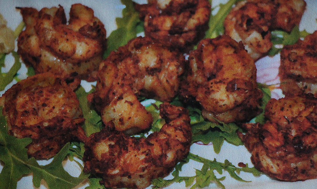 Spicy barbecued shrimp cool off on a bed of greens.