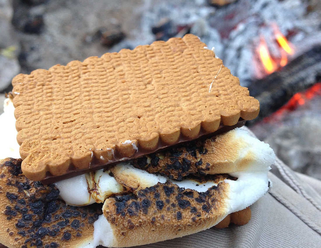Molten marshmallow cools between two pieces of graham cracker.