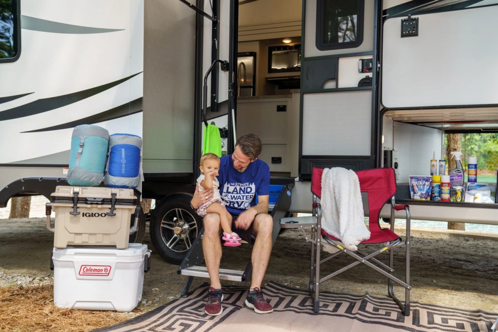 Father and Baby Spend Quality Time Outside Their Cargo RV