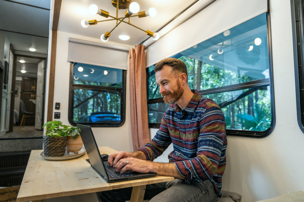 Man Working Remotely on Laptop from RV