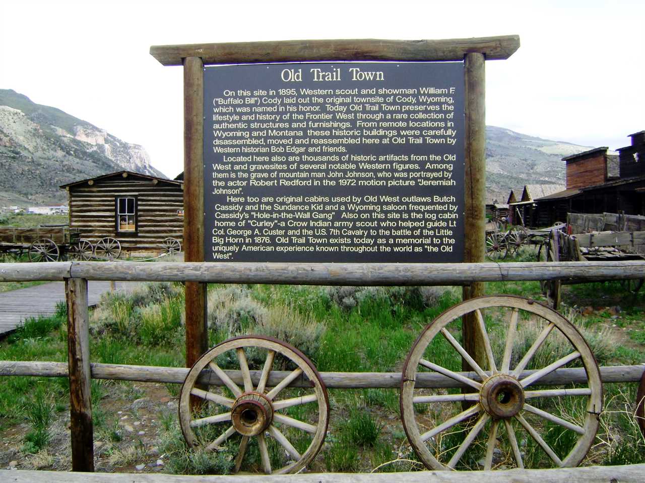 Sign with the heading "Old Trail Town" with Old West buildings in the background.