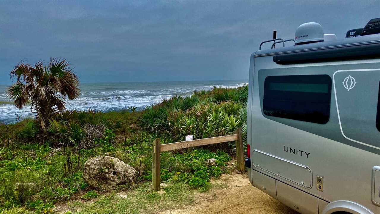 class b rv parked at beach campsite.