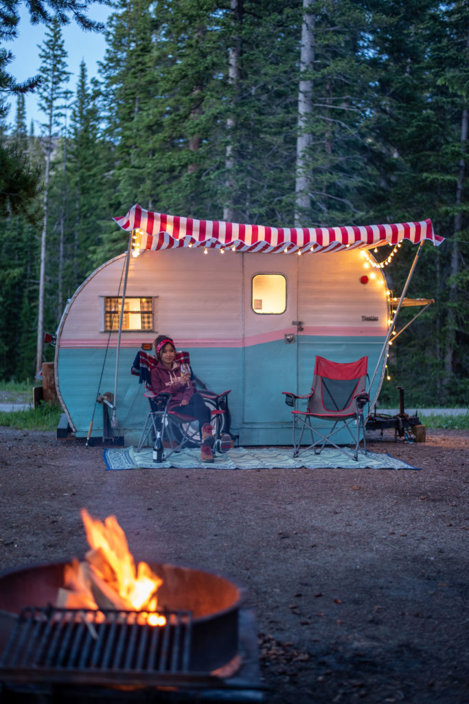 Retro RV with String Lights by Campfire