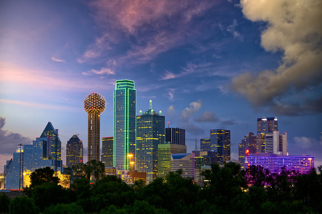 Glittering city skyline against evening sky.