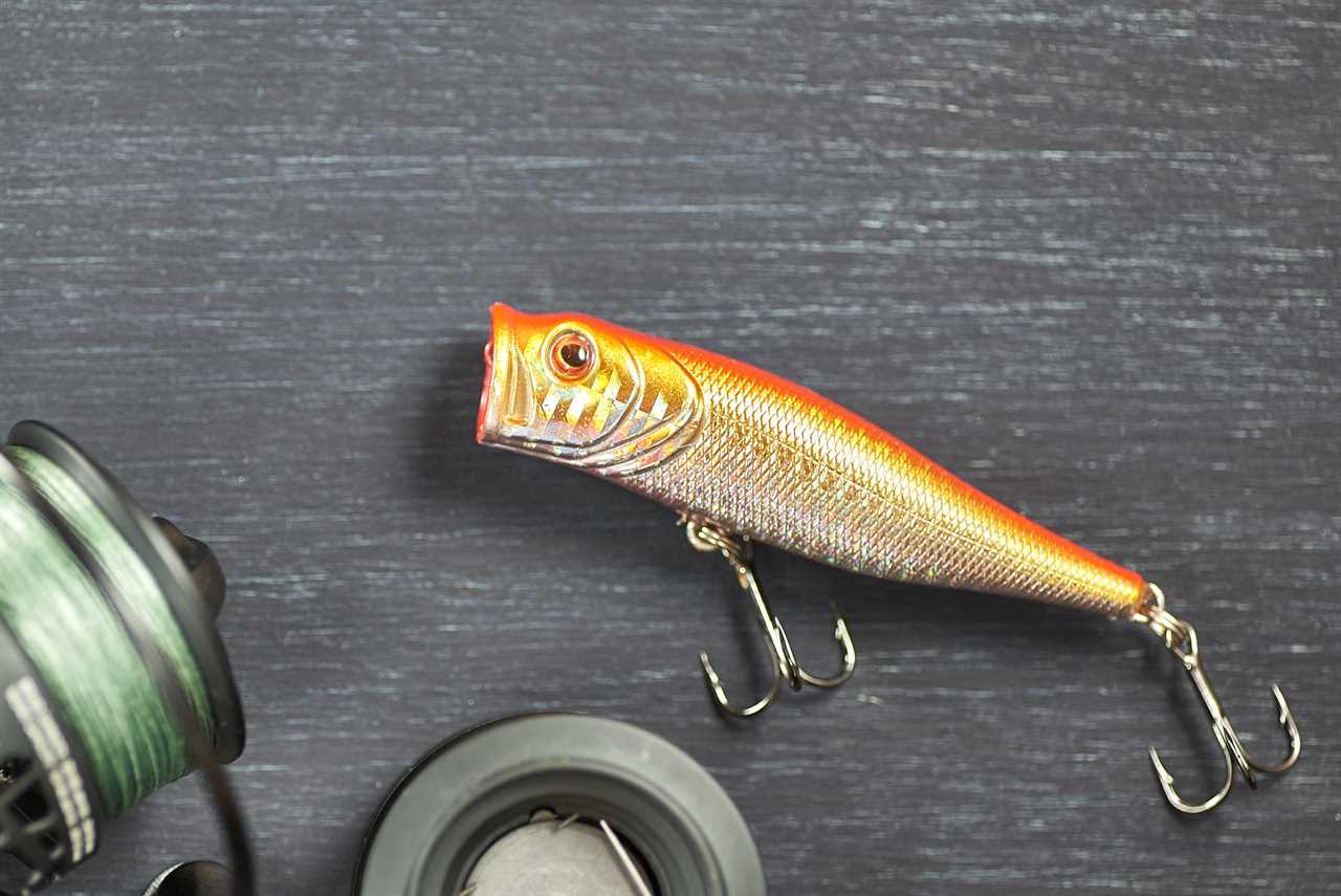 Horizontal shot of fishing bait and reel on a wooden table. Fisherman's kit.