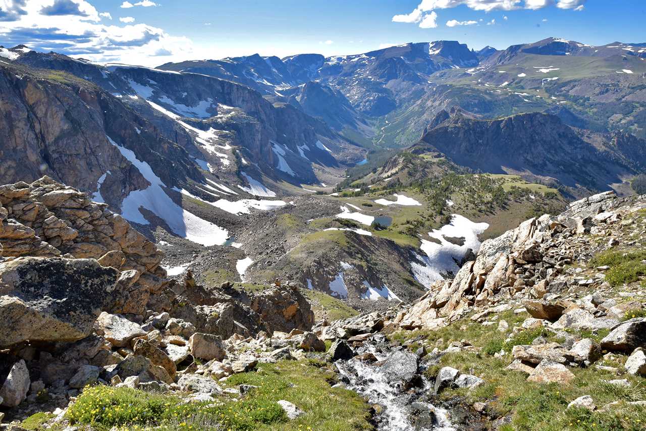 A small, bubbling stream runs down a valley 