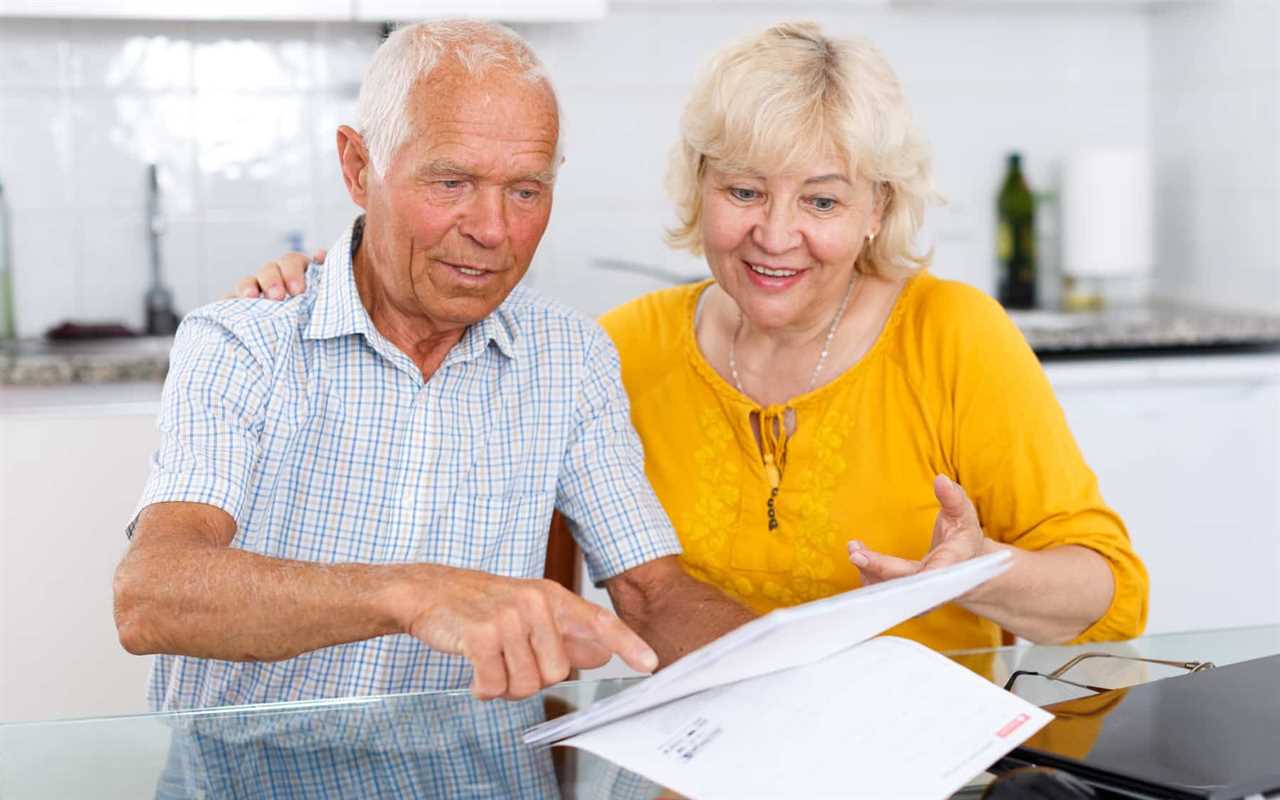 Portrait of a mature family couple with documents at kitchen table