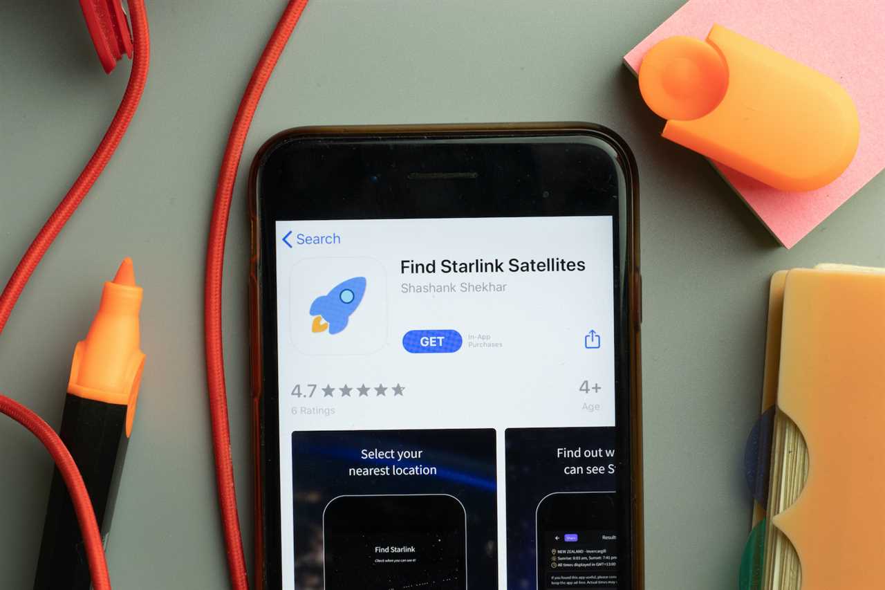 Phone screen close-up with Find Starlink Satellites mobile app logo on display