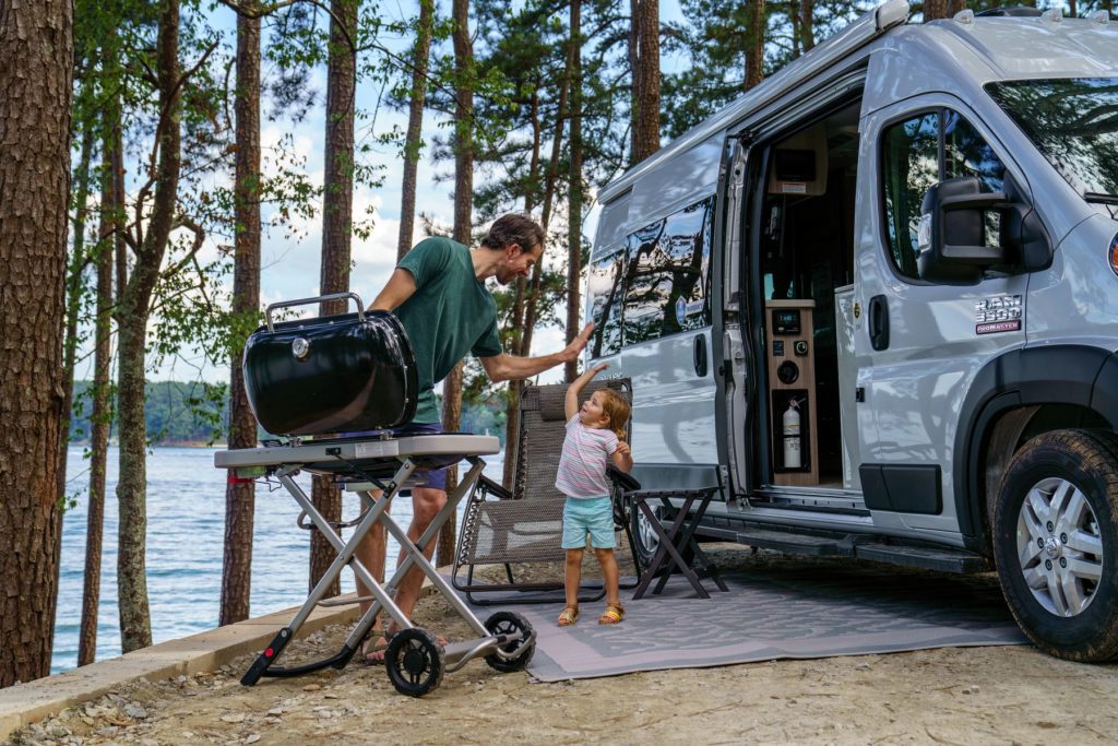 Father and Daughter Grilling by RV and Lake