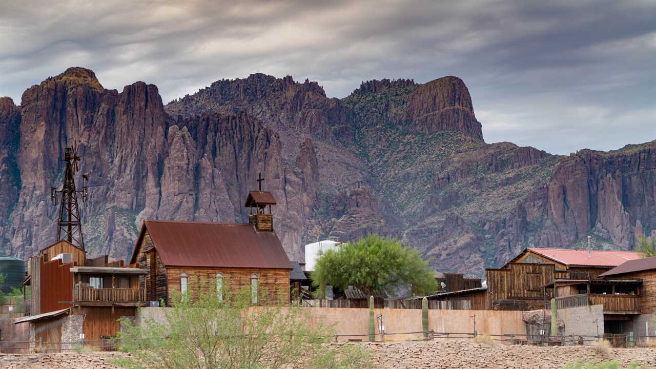 Old, delapidated buildings against rugged mountains