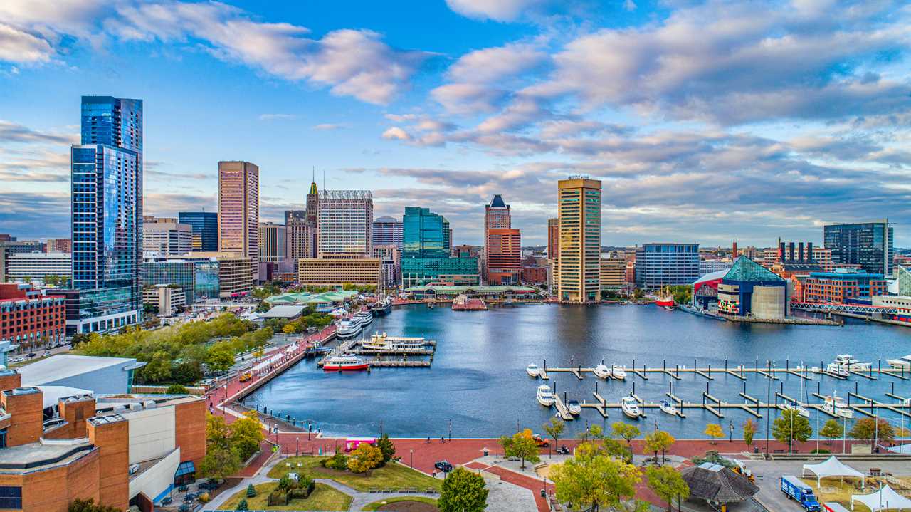 Bustling harbor under towering skyscrapers.