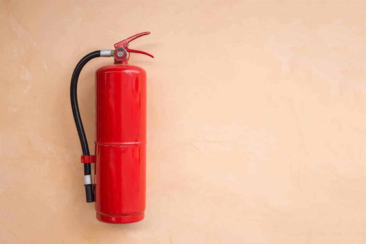 New red fire extinguisher tank on orange wall