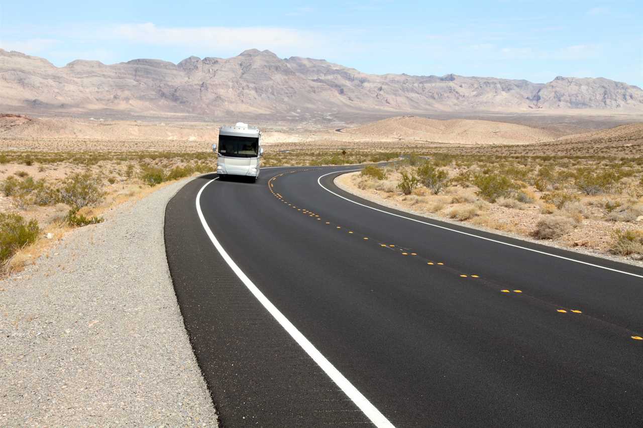 RV taking a slow turn with desert mountains in background.