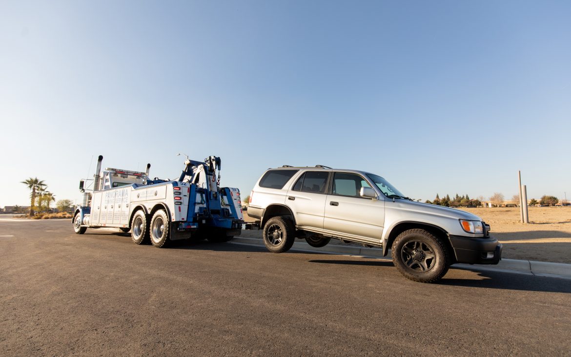 Tow truck towing SUV