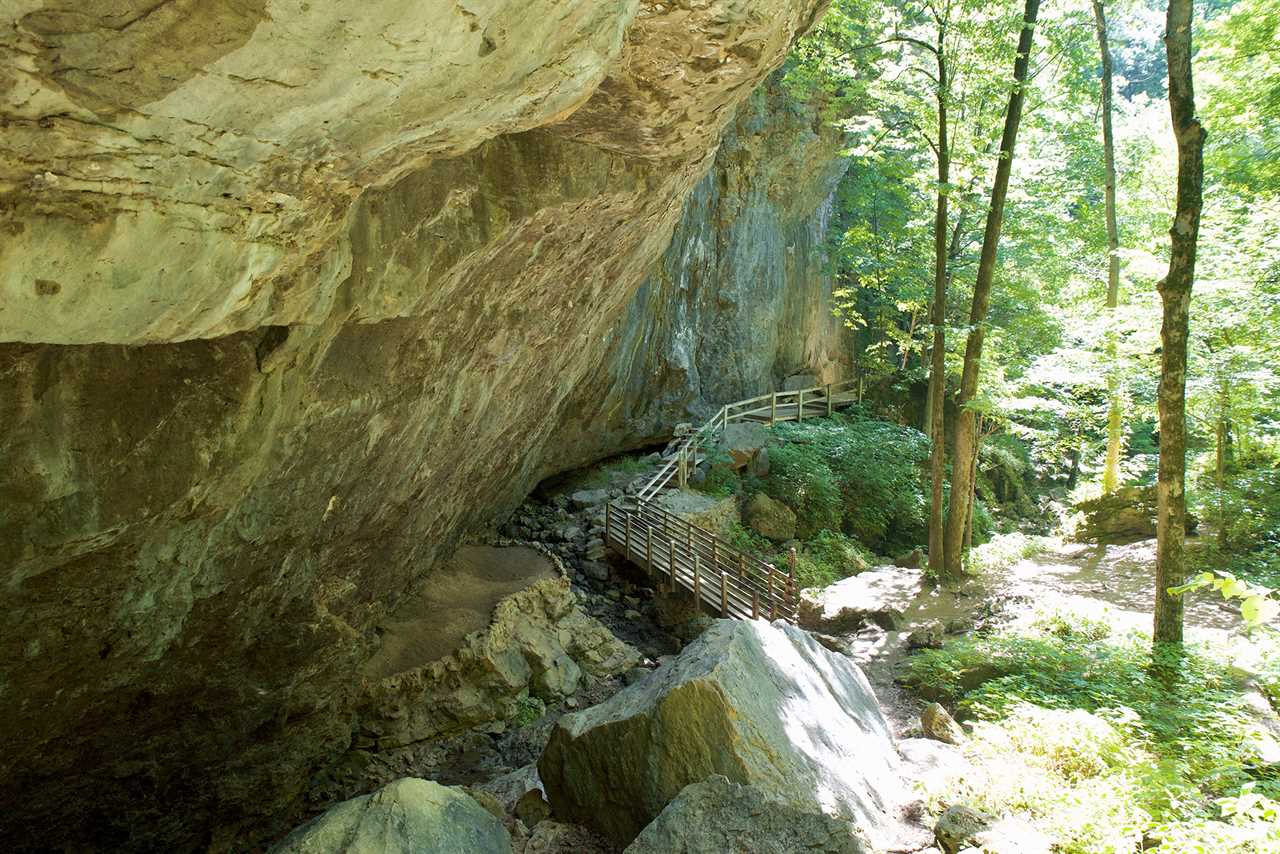 A tall cliff with a walkway hugging its base.