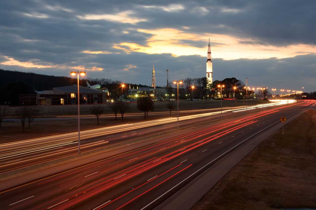 A rocket looms over a freeway. 