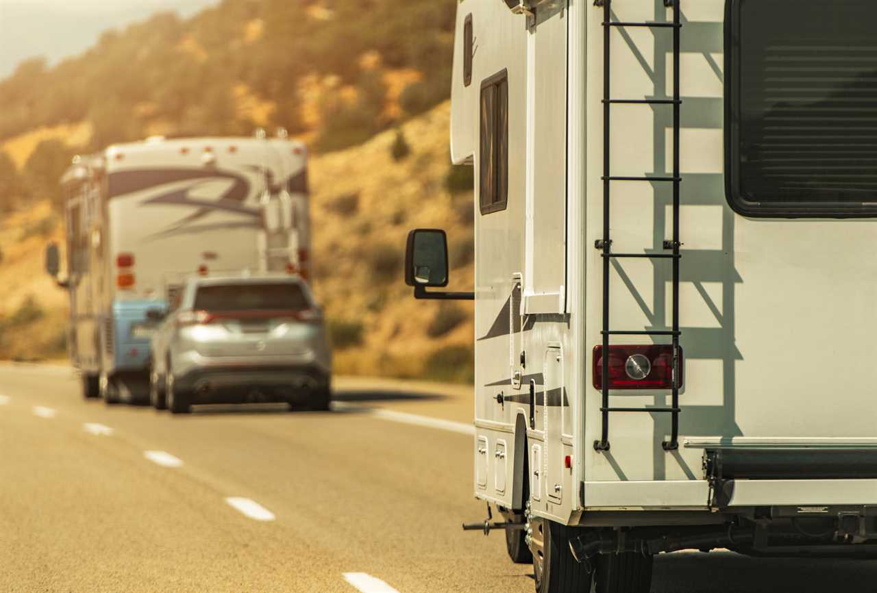 motorhome with dinghy and class C driving on a road