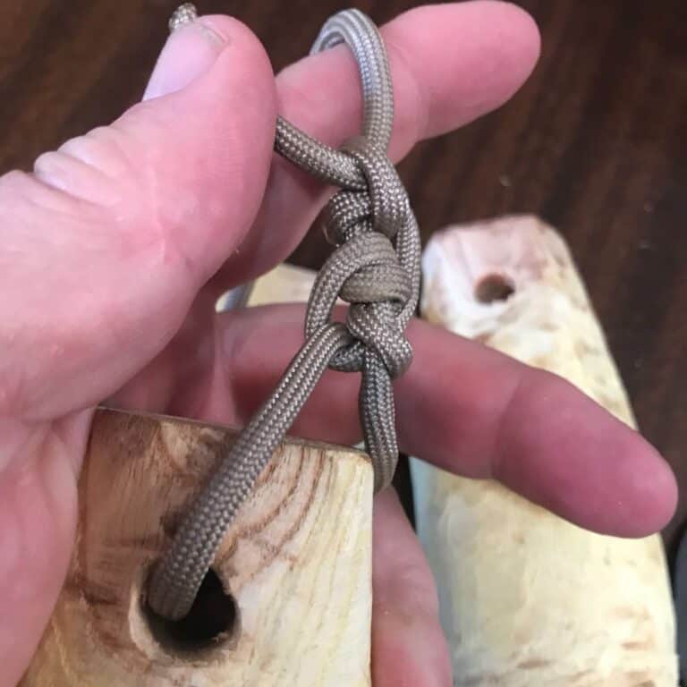 cord attached to wooden weight