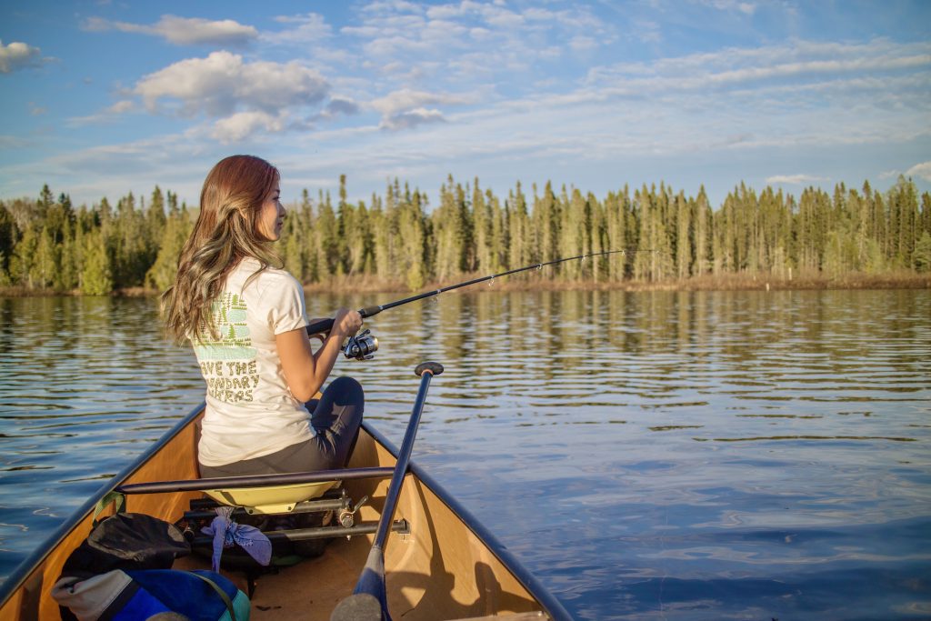 Jenny Anderson canoe fishing on a lake in Superior National Forest