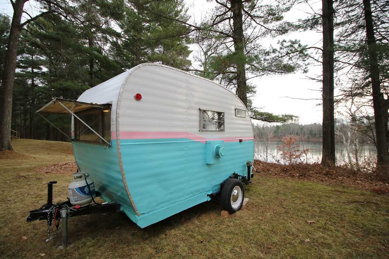Vintage camper next to lake