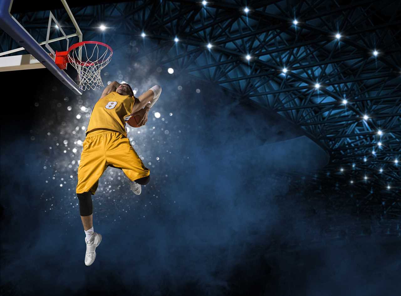 A basketball player in the act of dunking.