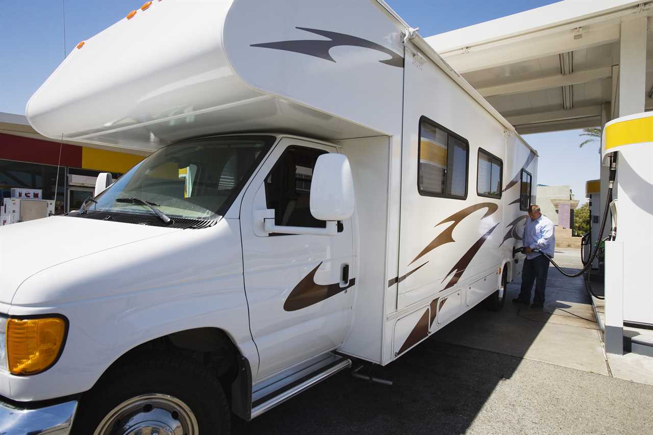 Class C motorhome at gas station.