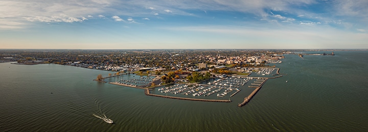 Incredible aerial city skyline wide angle panorama photograph of bustling waterfront city.