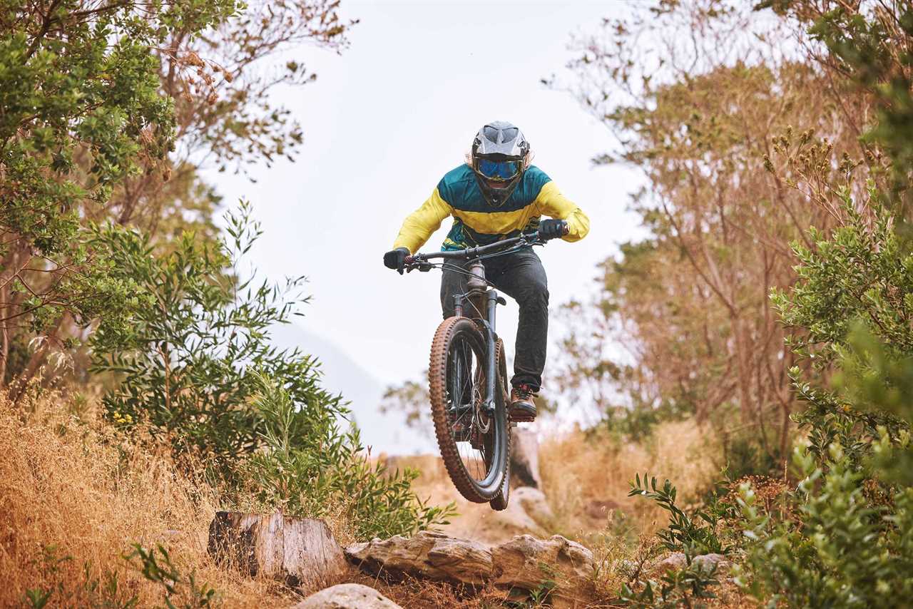 Bike rider takes a jump on a trail.