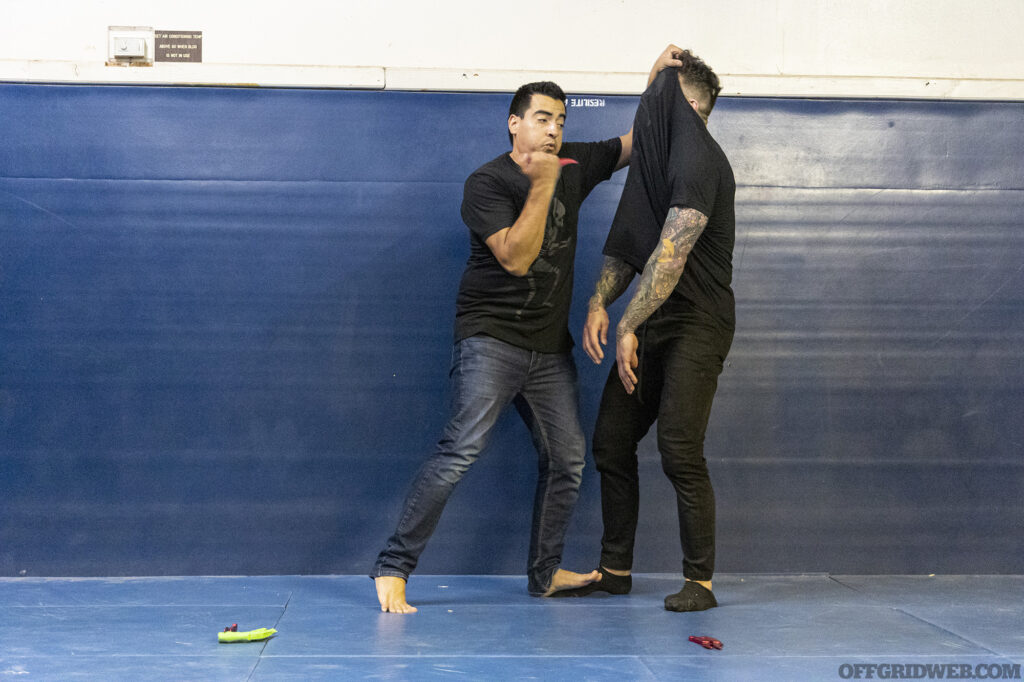 Ed Calderon demonstrating a defensive maneuver in which the opponents shirt is pulled over their own face, obscuring their vision during Protector Symposium 5.0.