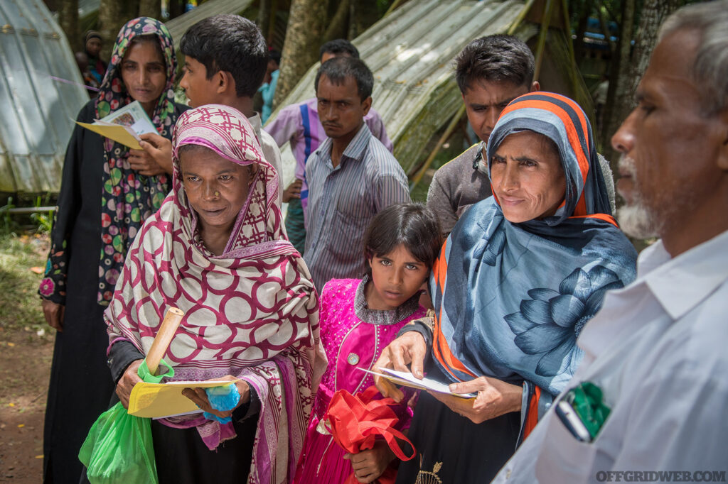 Photo of several Bangladeshi people waiting for supplies after a cyclone destroyed their homes.