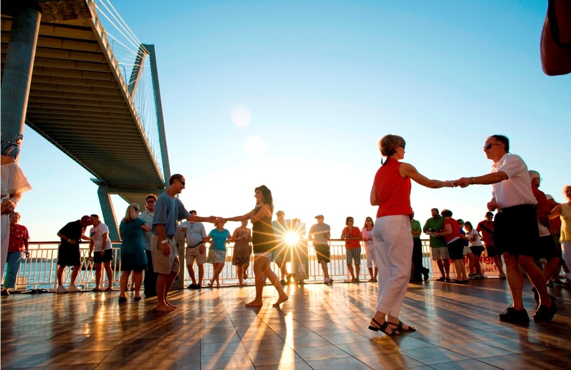 People dancing on outdoor dance floor during day