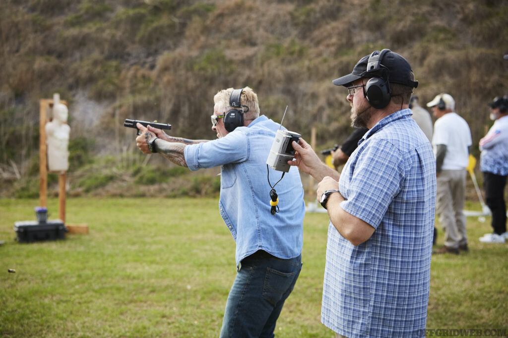 Photo of John Hearne supervising handgun training.