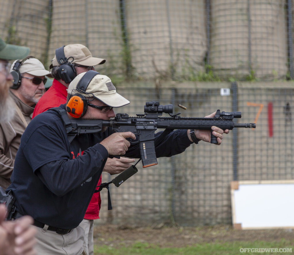 Photo of John Hearne conducting AR training at a firing range.