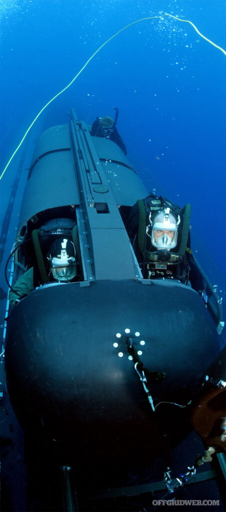 Photo of freedivers using advanced dive equipment to expedite their travel underwater while survival breathing.