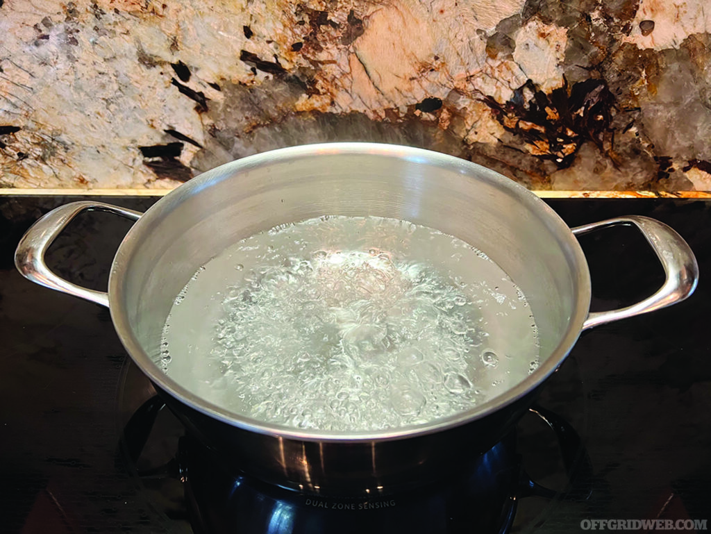 Photo of a pot of boiling water on a stove as a water purification method.