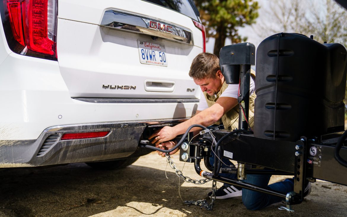 Hooking up a vehicle to a travel trailer.