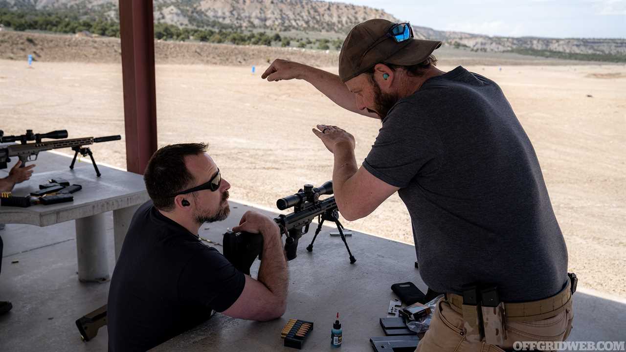 Photo of Patrick Diedrich discussing firing solutions with Jeff Wood.