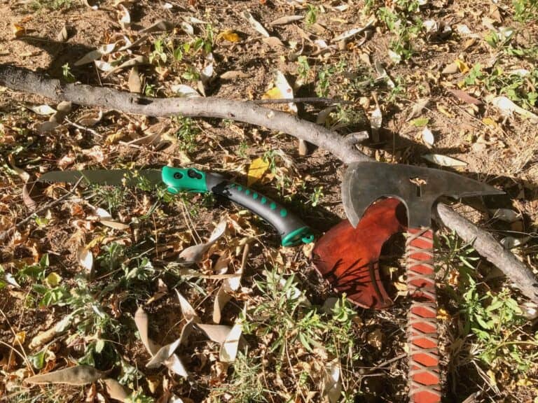 wooden stick next to tomahawk and knife