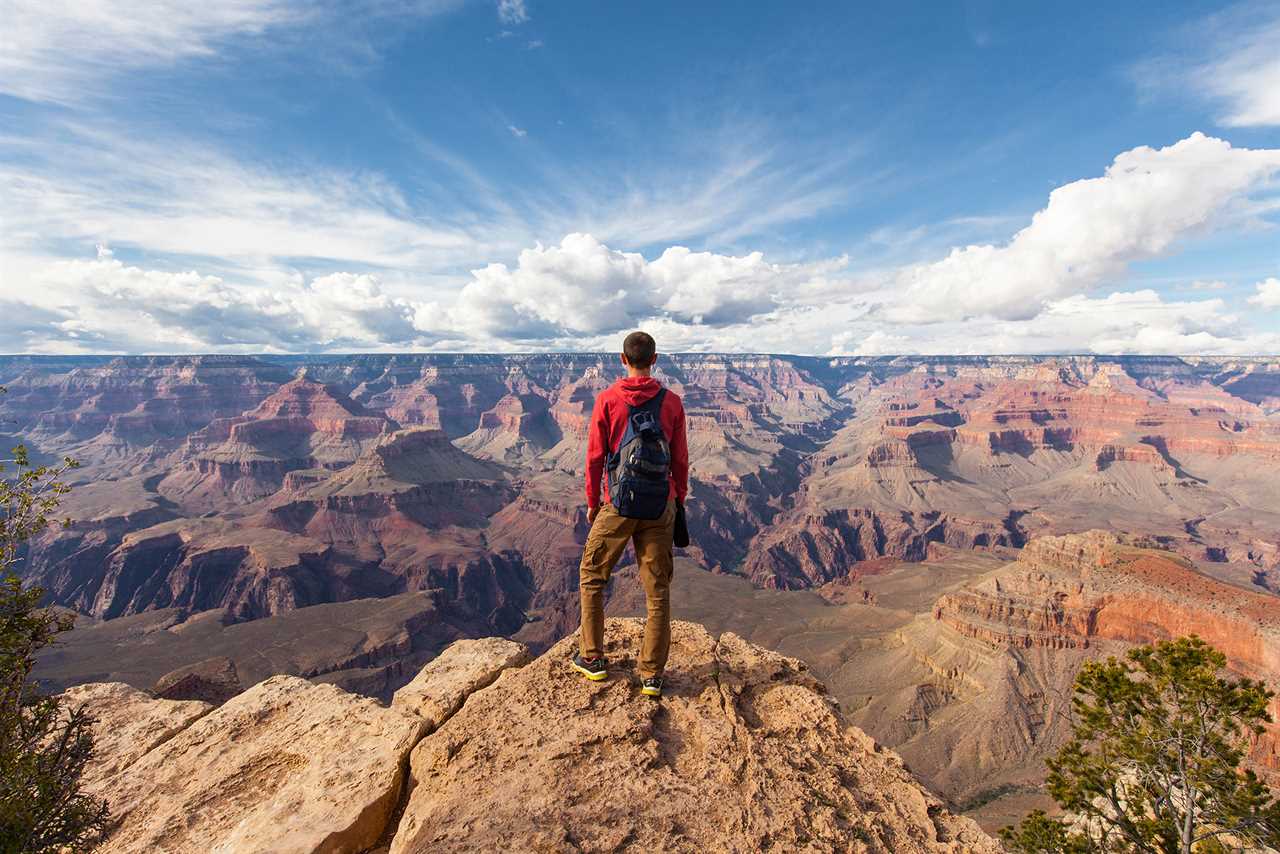 First camping trip — lone hiker looks out over vast canyon