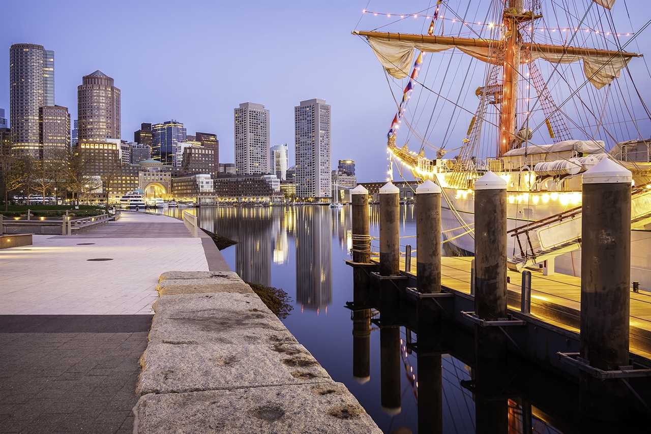 Historical sailing ship juxtaposed against modern skyline.