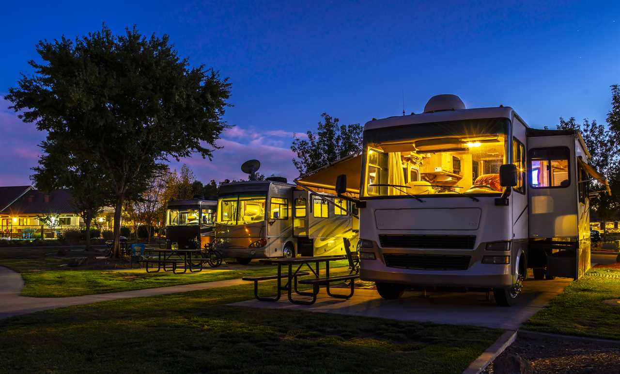 Class A motorhomes illuminated with windows uncovered.