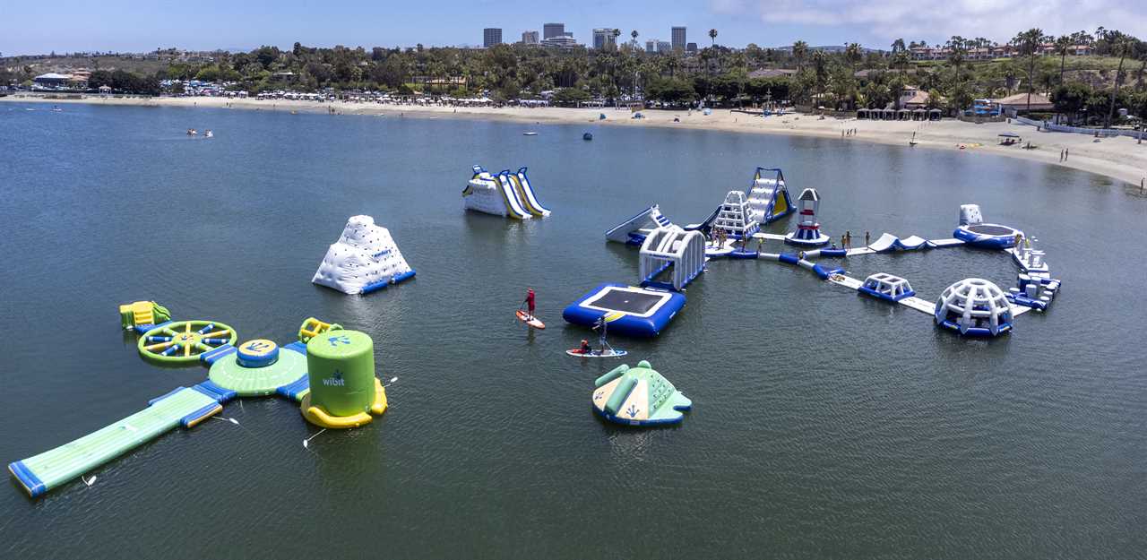 Aerial shot of floating play structures in a lagoon.